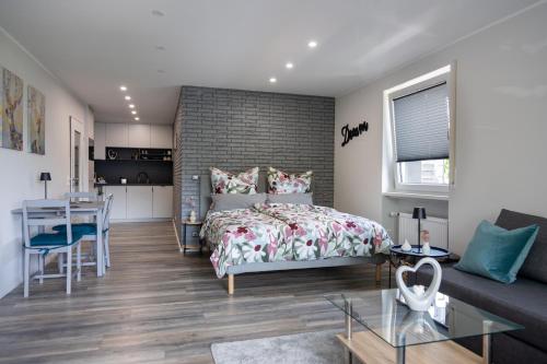 a bedroom with a bed and a dining room at Harzerfüllt in Hahnenklee in Hahnenklee-Bockswiese