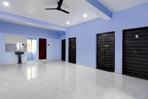a room with black garage doors and a ceiling at Super Hotel O MNJ Mansion in Bhubaneshwar