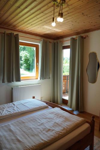 a bedroom with a large bed and a window at Apartmenthaus Schneider in Sielach
