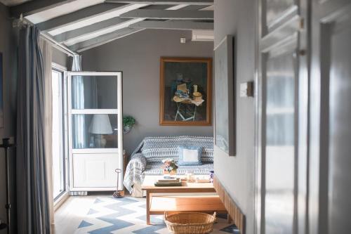 a living room with a blue couch and a window at Attic next to Agios Nikita's beach in Agios Nikitas