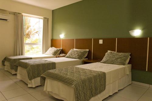 Tempat tidur dalam kamar di Hotel GAPH Maringa - Economico Mini Resort