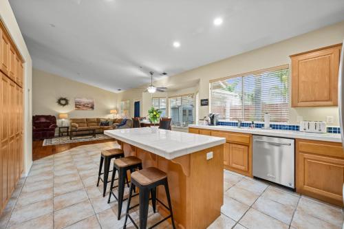 a kitchen with a large island with bar stools at Explore Ramonas Vineyards Tranquil Home with Yard in Ramona