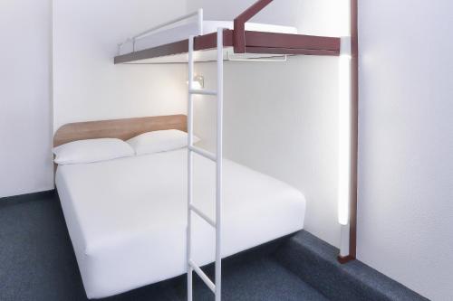 a bunk bed with a ladder in a room at SUN1 Parow Cape Town in Avondale