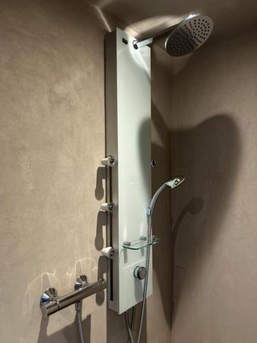 a shower stall in a bathroom with a shower head at WohnRaum Gäste- & Boardinghaus in Gusterath
