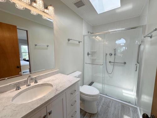 a bathroom with a shower and a sink and a toilet at SH153 Southern Shores 153 in Duck