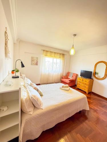 a bedroom with a large bed and a couch at Superhost Stay Garden View Double Room near Lisbon and Beaches in Corroios
