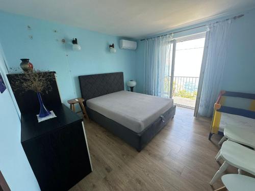a bedroom with a bed and a large window at Apartment Varga in Sveti Juraj