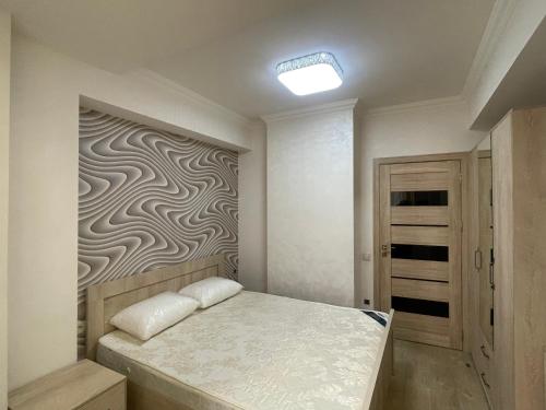 a bedroom with a bed with a wall mural at Caribian Apartment in Yerevan