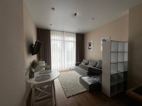 a living room with a couch and a table at Smart House Apartments in Lviv