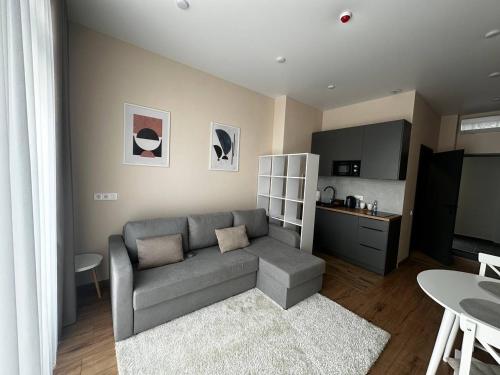 a living room with a couch and a kitchen at Smart House Apartments in Lviv