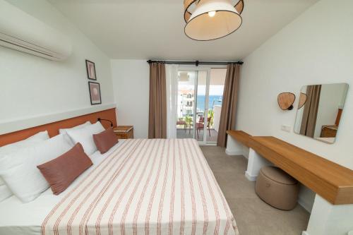 a hotel room with a bed and a mirror at Diplomat Suites in Marmaris