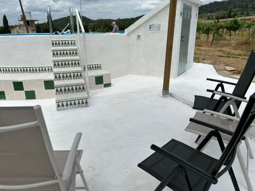 a group of chairs sitting on a patio at La Caseta Vella in Falset