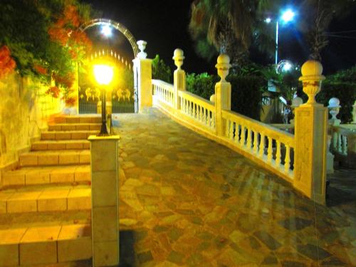a white fence and stairs with a light on it at Castellino Zwillingsstudios 1 in Kallithea Rhodes
