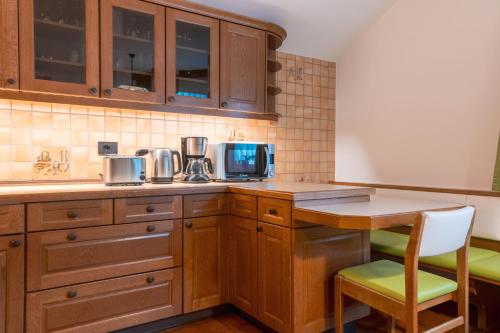a kitchen with wooden cabinets and a table and chairs at Apartment Christian in Ortisei