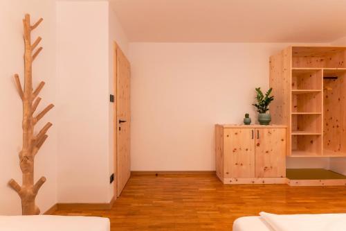 a room with white walls and a door and wooden floors at Apartment Christian in Ortisei