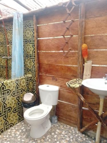 a bathroom with a toilet and a sink at Lovely Amazon Rainforest Retreat 