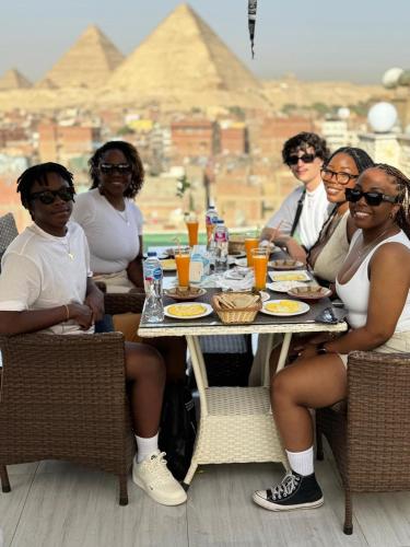 a group of women sitting around a table at home in the pyramids in Cairo