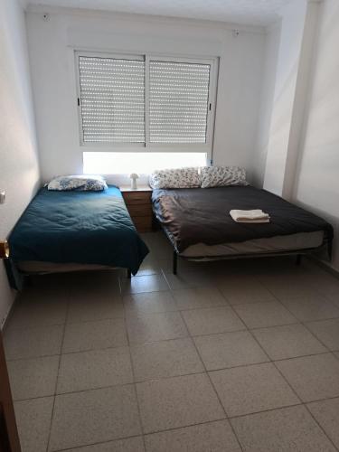 Postel nebo postele na pokoji v ubytování CASA COMPARTIDA SIn ASCENSOR ELDA
