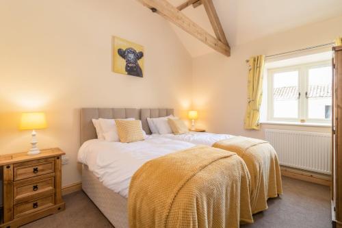 a bedroom with two beds and a window at Grange Cottage in York