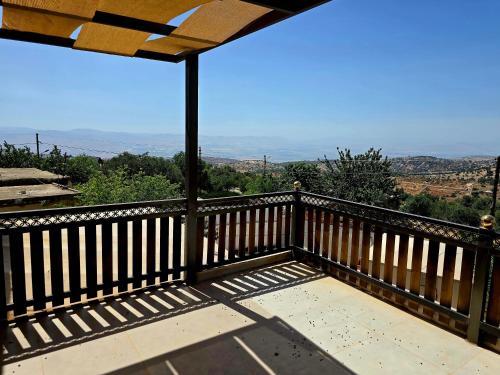 a balcony with a view of the mountains at Charming Farmhouse for Lease in Ed Deir