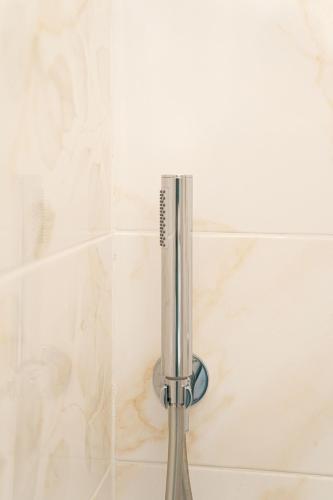a shower head in a shower stall with a shower at Aragona Bed & Breakfast in Santa Maria a Vico