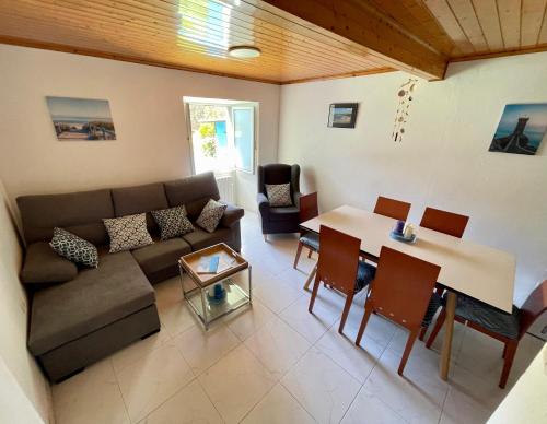 a living room with a couch and a table at Casa do Cucharro en Playa de Soesto, Laxe in Laxe