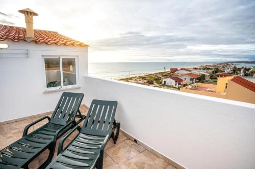 two chairs on a balcony with a view of the ocean at Blife Benya private apartment in Faro