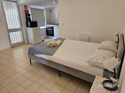 a bedroom with a large bed with two pillows on it at Blife Benya private apartment in Faro
