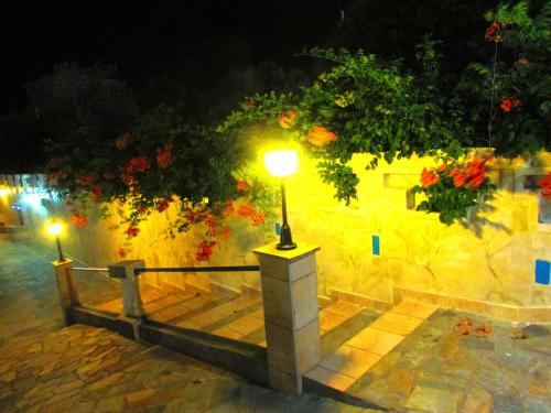 a light on a stone wall at night at Castellino Zwillingsstudios 2 in Kallithea Rhodes