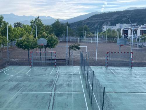 a tennis court with two basketball nets on it at Atalaya Peña Telera Margas Golf in Sabiñánigo