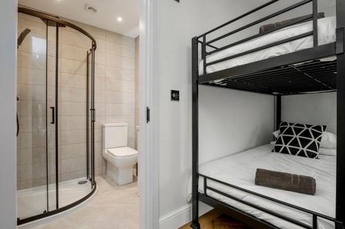 a bathroom with two bunk beds and a shower at The Boot Rooms Anfield in Liverpool