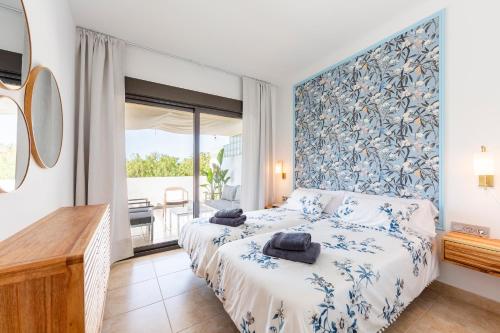 a bedroom with two beds and a large window at Golf Beach Vera in Vera