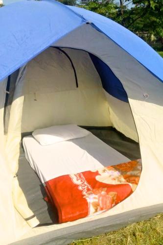 a blue and white tent with a bed in it at Shegadia Camp in Lotus Island