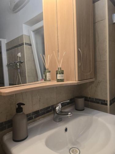 a bathroom sink with a soap dispenser on top of it at Syra & Hermes Home in Ermoupoli