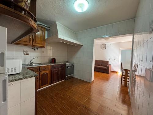 a kitchen with a sink and a stove at Casa Outeiro Polo 1 in Marinhas