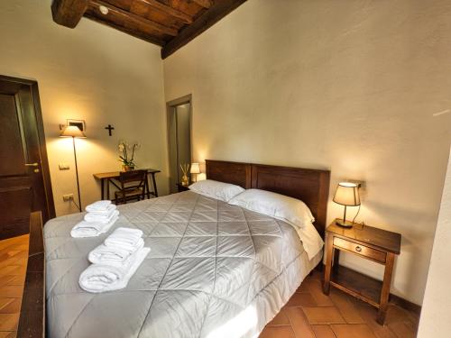 a bedroom with a large bed with towels on it at Abbazia dei Santi Felice e Mauro in Castel San Felice