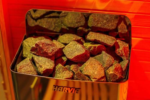 a metal container of rocks in a red background at Hotel de Prince in Nijmegen
