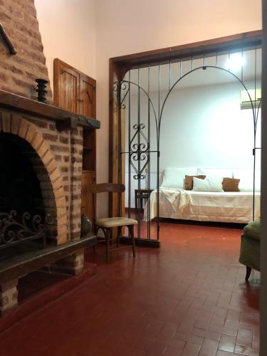 a living room with a fireplace and a bed at Las Vellon in San Pedro