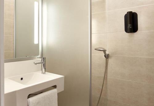 a bathroom with a sink and a shower at B&B HOTEL Cergy Saint Christophe in Cergy