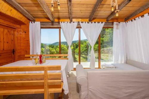 a bedroom with two beds and a large window at Holiday home in Grizane 45281 in Grižane