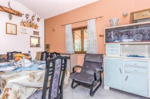 a room with chairs and a table and a cabinet at Holiday home in Dolenja Vas - Istrien 51824 in Dolenja Vas