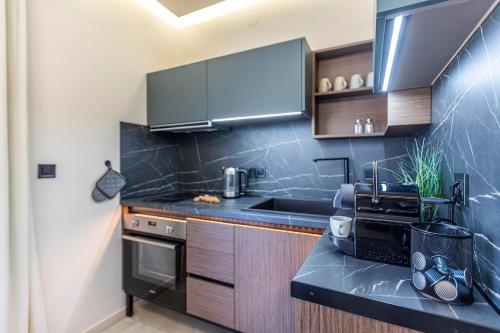 a kitchen with a black counter top and wooden cabinets at Aegean View in Metamorfosi