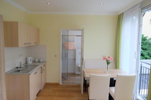 a kitchen and dining room with a table and chairs at Panorama-Café MOSELGARTEN in Alf