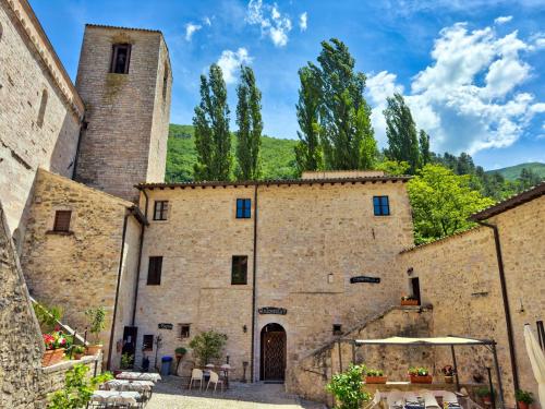 an old stone building with two towers at Abbazia dei Santi Felice e Mauro in Castel San Felice