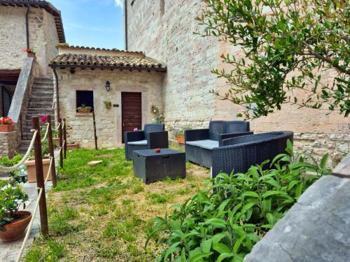 a yard with two blue chairs and a table at Abbazia dei Santi Felice e Mauro in Castel San Felice