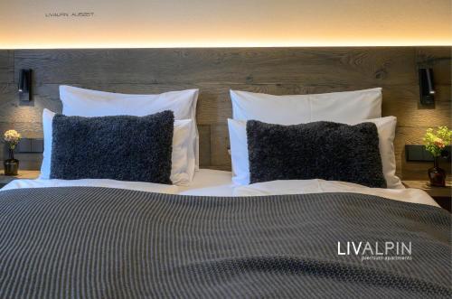a bedroom with a bed with two pillows at LIVALPIN Relaxe in Garmisch-Partenkirchen