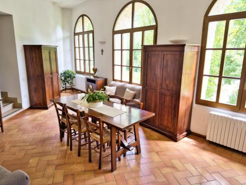 a dining room with a wooden table and chairs at Abbazia dei Santi Felice e Mauro in Castel San Felice