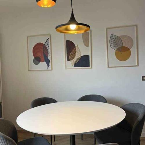 a room with a white table and some chairs at Apartments in Mezzolago di Ledro - Ledrosee 54438 in Mezzolago
