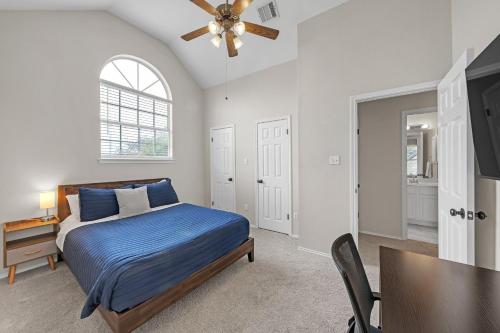 a bedroom with a bed and a ceiling fan at Modern 4BR Gem Chic Comfort in Austin home in Austin