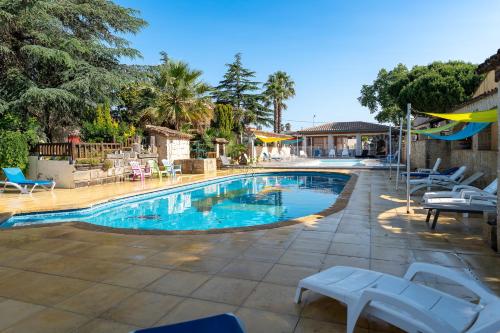 Una gran piscina con sillas y una mesa. en Gites Le Pressoir, en Vias